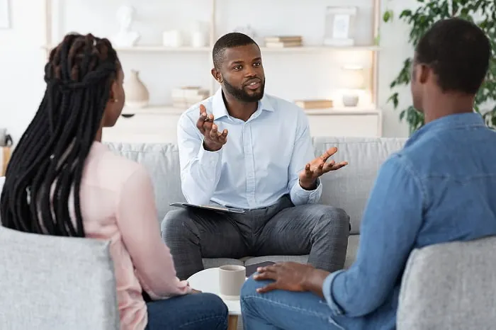 A counselor meeting with a couple